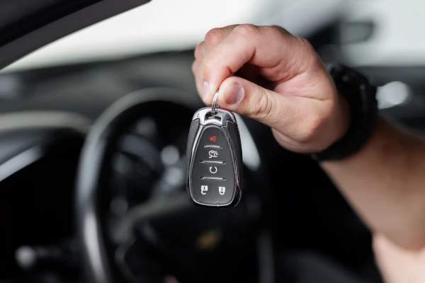 Hand of a male driver holding car keys, close-up.