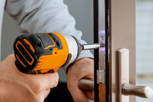 Locksmith installing new door lock